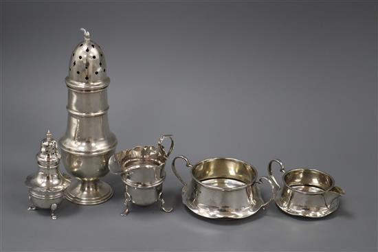 A 1930s silver sugar caster, two silver cream jugs, a sugar bowl and pepperette.
